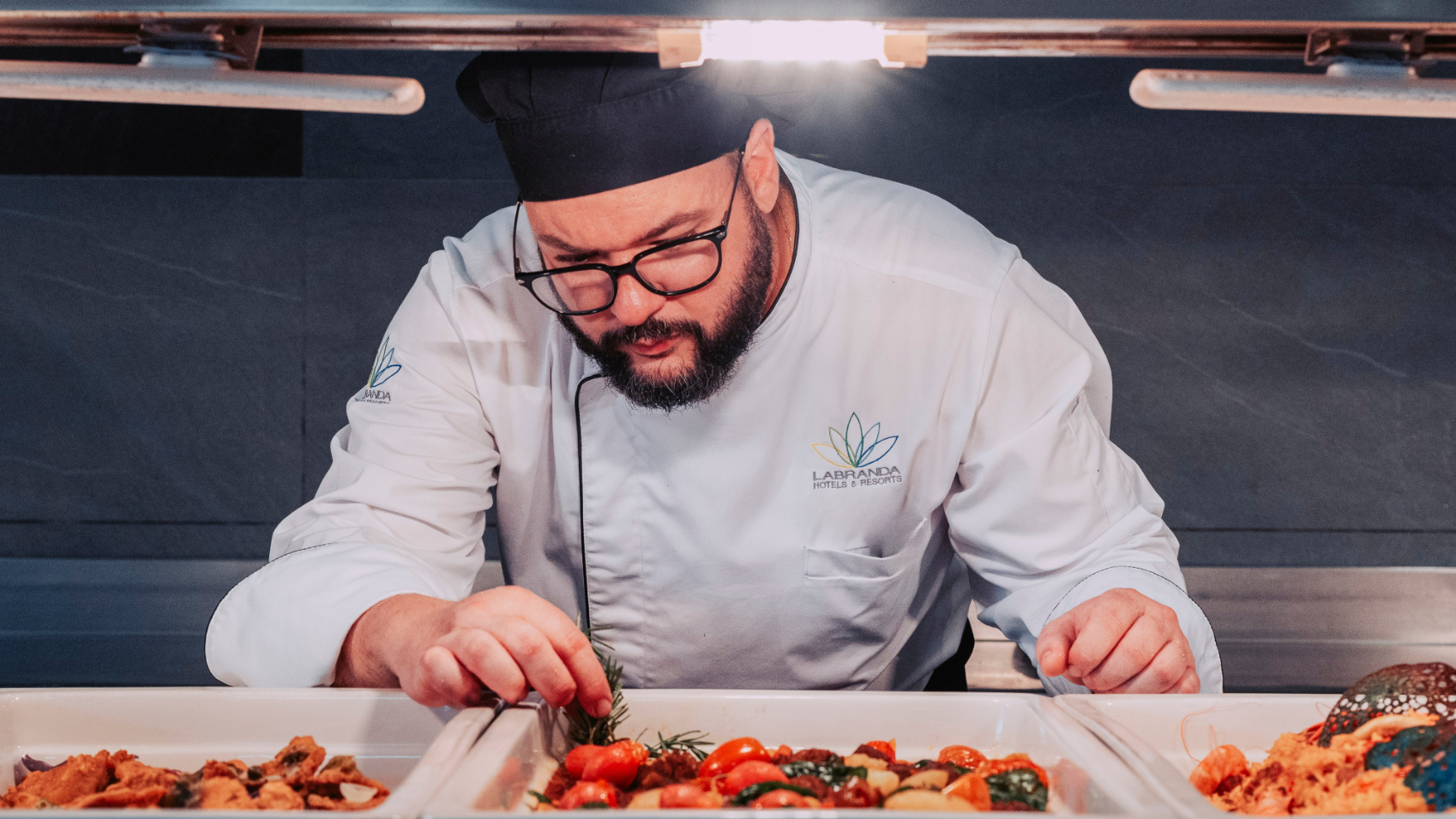 A waitress by the tables in La Cascada at Labranda Marieta